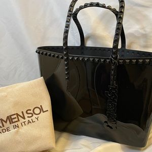 Carmen’s Sol black purse. Med size. Still smell of their scent of roses.